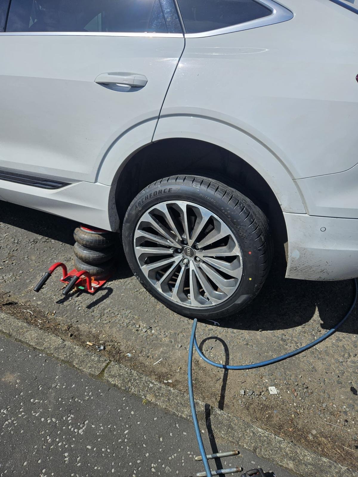 Flat tyre on an East End Glasgow street before mobile tyre fitting in Dennistoun]