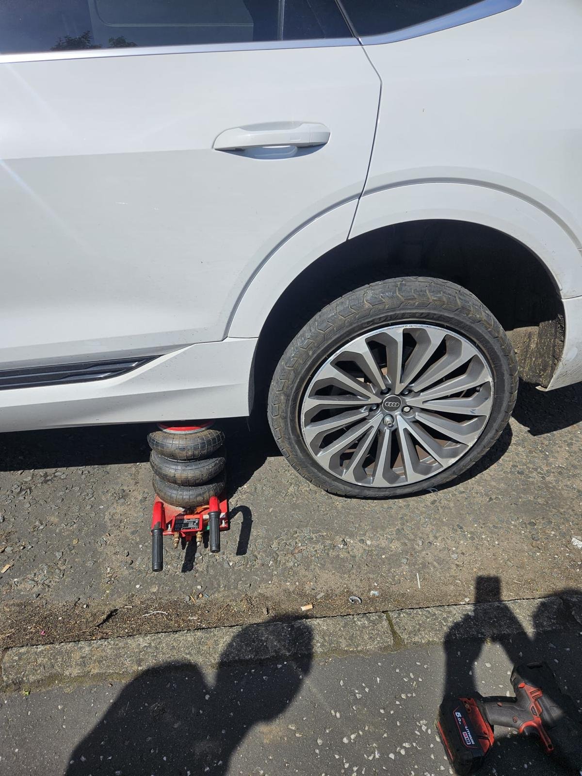 Close-up of a technician balancing a car wheel during mobile tyre fitting